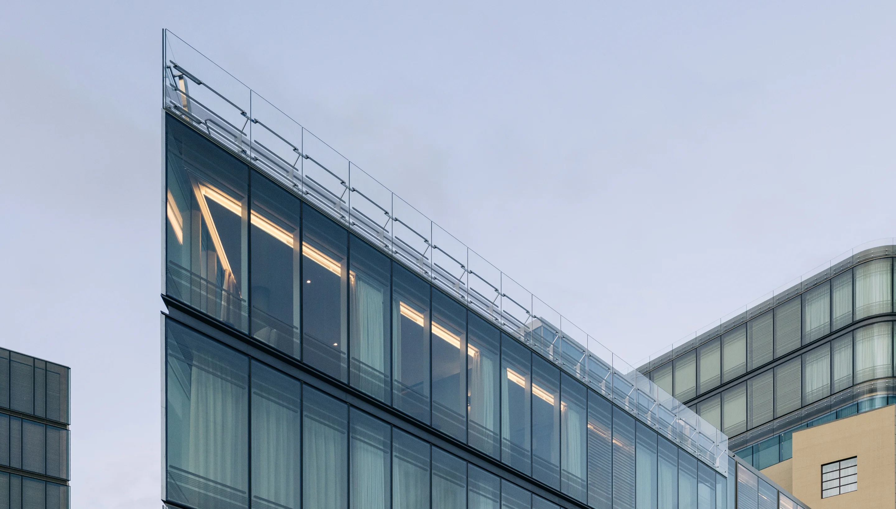 External view of top levels of glass front building