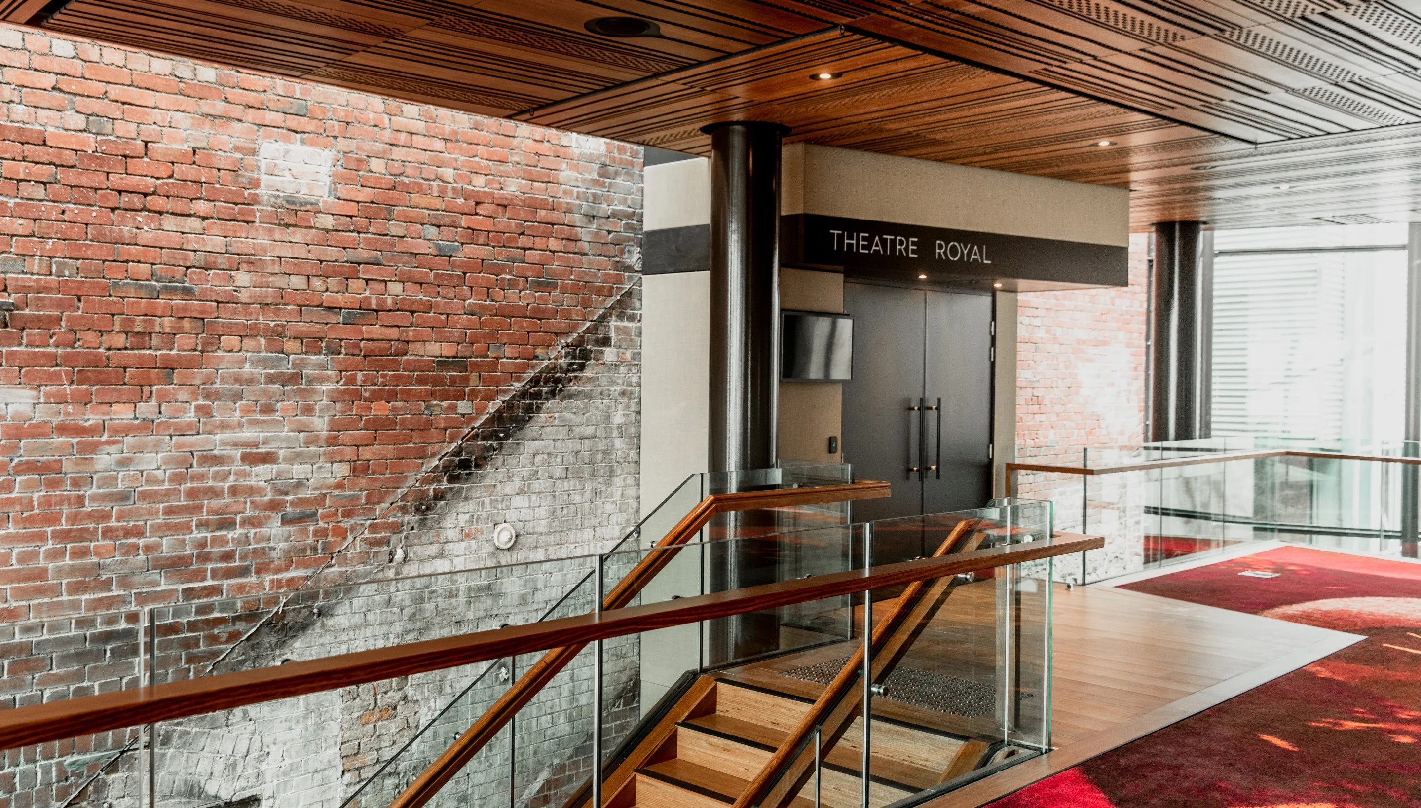 Internal view of wooden staircase inside brick building